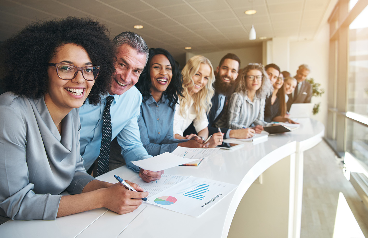 Employees at table smiling