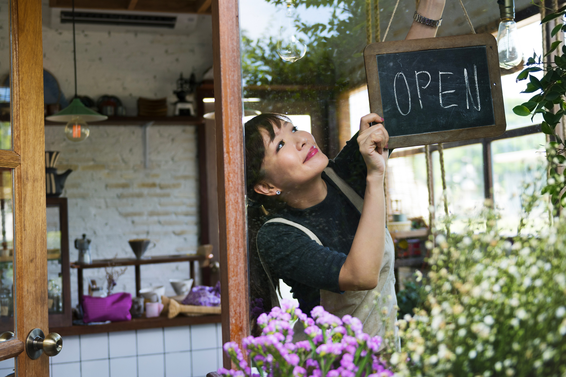 Woman hanging open sign